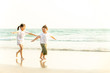 © CandyRetriever  - Happy little Asian brother and sister running and playing with smiling and laughing together on the beach at sunset. Adorable kids girl and boy relax and having fun in summer holiday vacation travel.