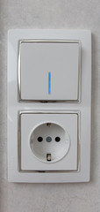 socket on a light gray wall, multi-function socket with Internet access and switch