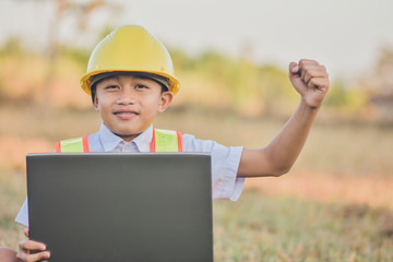 Boy kid engineer hard hat using computer outdoor