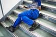 © Andrey Popov - Worker Man Lying On Staircase