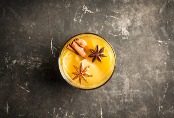 Healthy hot beverage with lemon, ginger and spices for protection in flu season. Selective focus. Shallow depth of field.