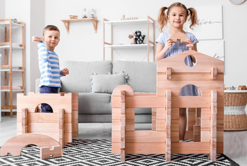 Wall Mural - Little children playing with take-apart house at home