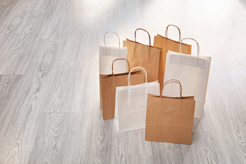 Many paper shopping bags on floor