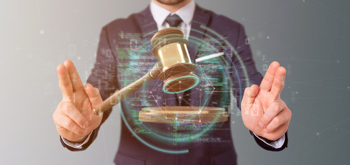 Poster - Businessman holding a Justice hammer and data - 3d rendering