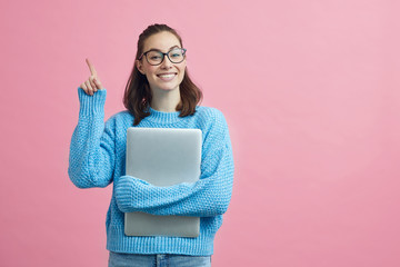 Smart looking student on colorful background holding her finger up to signal that she have an good idea 