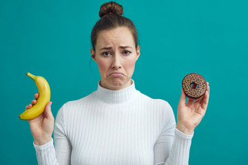 Wall Mural - Young woman sad for being on a diet and can't eat the sweet cake 