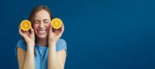 Girl Fooling Around With Oranges On A Nice Contrast Background