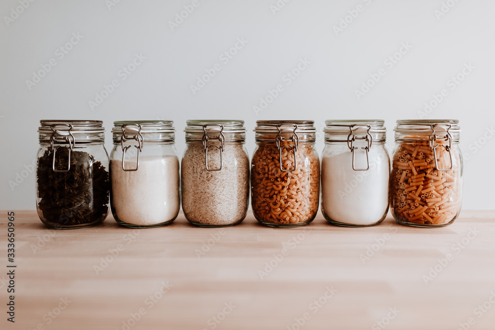 Six glass jars full with dried uncooked food ingredients - obrazy, fototapety, plakaty 