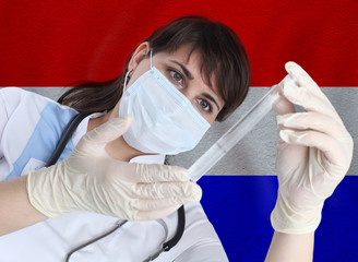 Scientist woman with test tube Coronavirus or COVID-19 against Netherlands flag. Research of viruses in laboratory for prevention of a pandemic in Netherlands