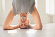 Man practicing yoga and standing in headstand pose