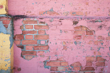 Old Peeling Pink Painted Brick Wall.