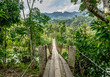 Wooden scary hanging bridge in amazing jungle near Bukit Barisan mountain range Leuser ecosystem in Banda Aceh, Sumatra, Indonesia