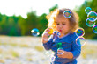 © Serafima - horizontal defocused photo of funny curly-haired girl with soap bubbles