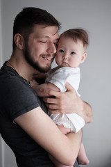 Wall Mural - Portrait of a small child in the arms of his father..