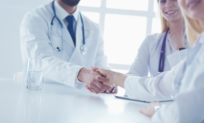 Wall Mural - Doctor shaking hands with a male patient in the office