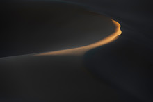 Abstract Desert Sand Dunes With Deep Shadows And Early Morning Light.