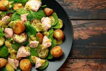 Wall Mural - Salmon, new potato, courgette and spinach salad on wooden table