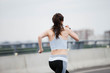 Fitness sport girl on intensive evening run, attractive runner jogging outdoors, female jogger in bright sportswear.