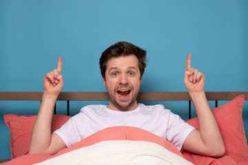 Sticker - Caucasian man resting in bed on quarantine pointing up