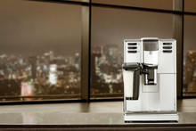 Coffee Machine In Office And Blurred Window Of City At Night 