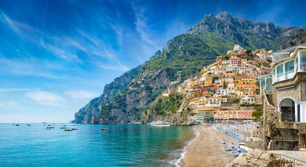 Wall Mural - Beautiful Positano with colorful architecture on hills leading down to coast, comfortable beaches and azure sea on Amalfi Coast in Campania, Italy.