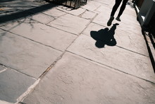 Shadow Of Person Walking On The Street