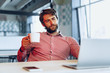 © fotofabrika - Puzzled thoughtful businessman sitting at his working table in an office. Business concept