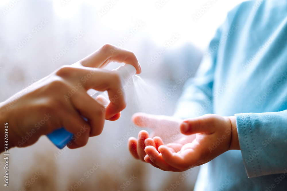Hands with sanitizer antiseptic. Mother and child using sanitize antiseptic for hand coronavirus protection.Hygiene concept. Prevent spread of germs and bacteria and avoid infections coronavirus. - obrazy, fototapety, plakaty 