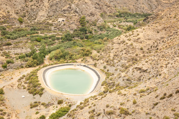 Round water reservoir to store water for agriculture on a semi desert landscape