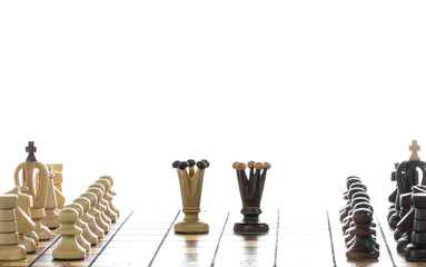 Face to face - two queen. Close up of chess pieces on board, isolated on white background.