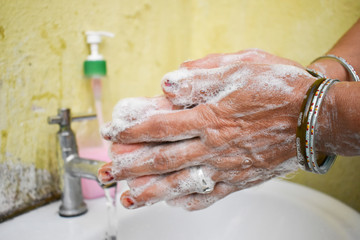  Woman washing hand in the sink