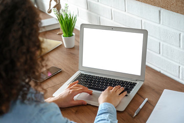 African girl school student e learning distance training course study work at home office. Ethnic young woman watching online education webinar using laptop. Over shoulder close up mock up screen view