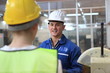 © sittinan - Male and Female Industrial Engineers in Hard Hats Discuss New Project while Using Laptop. They Work in a Heavy Industry Manufacturing Factory.