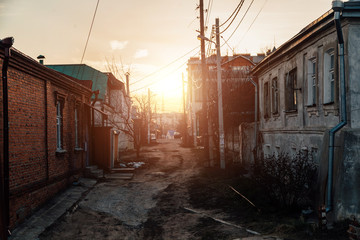 Wall Mural - Old houses on low-rise street in old poverty part of Voronezh city in Russia in sunset