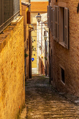 Wall Mural - View of a beautiful narrow steep street in Fermo, Province of Fermo, Marche Region, Italy