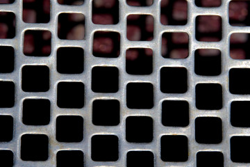 Abstract macro photography. Close up square grid pattern of steel material