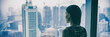 © Maridav - COVID-19 Quarantine mental health. Woman self isolated at home pensive looking out of high rise building window at city skyline thinking of relationship, employment, coronavirus. Panoramic banner.