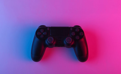 Wall Mural - Gamepad with neon blue-pink light. Gaming concept.