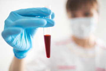 Novel Chinese Coronavirus blood test Concept. Nurse holding test tube with blood for 2019-nCoV analyzing.