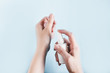 © Anntuan - Treatment of women's hands with antiseptic protection from coronavirus Covid-19 concept.