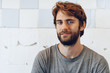 © fotofabrika - Close up Portrait of a young bearded man standing against grunge weathered wall