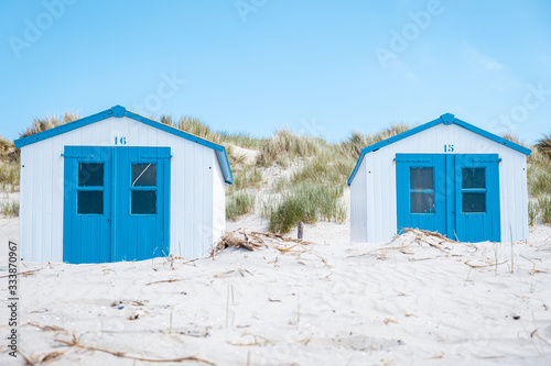 Texel Island Netherlands, blue white beach hut on the beach with on the backgrou Tableau sur Toile