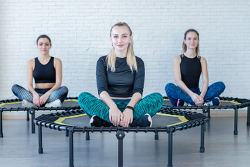 Wall Mural - a group of girls engaged in gymnastics fitness trampolines in the gym . girls train make stretching body flexibility smile and good mood