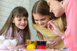 © madhourse - Family fun watching how the eggs are painted in a solution with dyes