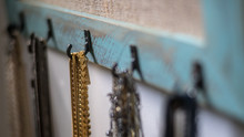 Isolated Close Up Of A Hand Made Chain Jewelry Rack Filled With A Wide Variety Of Colorful Jewels- Israel