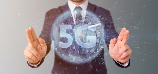Poster - Businessman holding a 5G connection with data surrounding - 3d rendering
