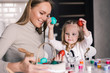© dianagrytsku - Loving mother and her daughter have fun with painting easter eggs. Cozy home atmosphere. Easter.
