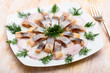 Marinated herring with sliced onion and dill