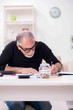 © Elnur - Old male retired in budget planning concept