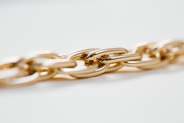 massive golden braided chain bracelet on a white background in isolation copy space place text